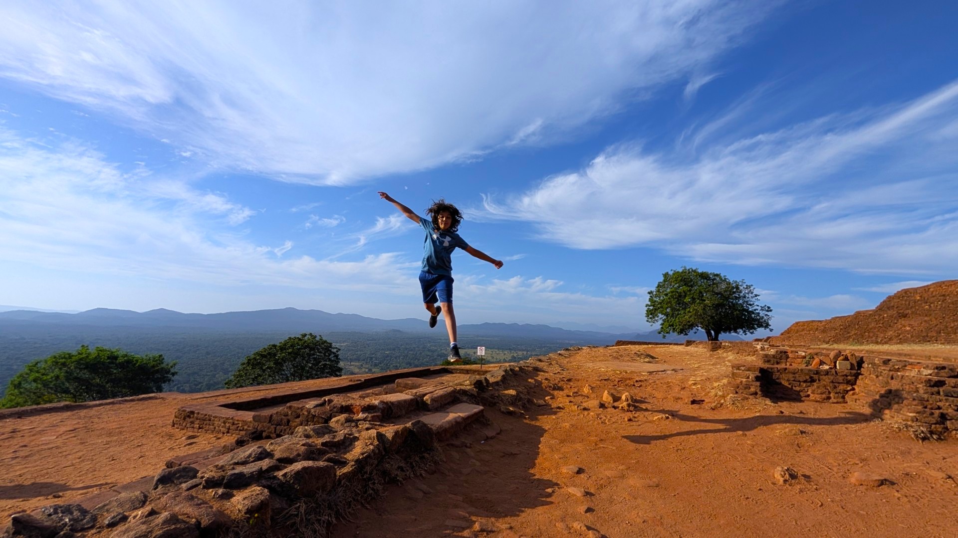 boy jumping at sigiriya sri lanka